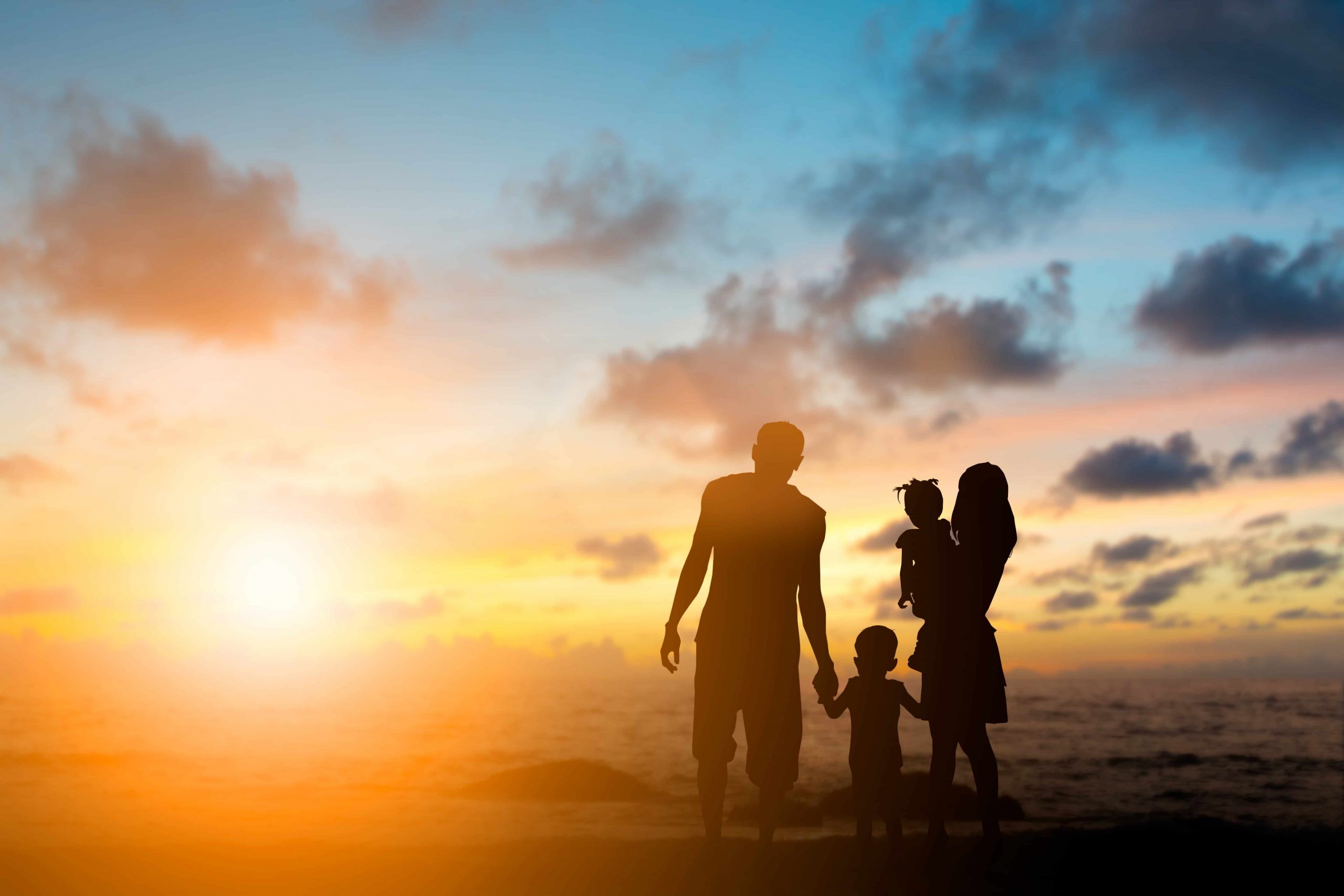 Silhouette family mother, father and young son holding hands, taking a swim in the sea for the first time the children are excited and delighted over blurred beautiful nature.Concept friendly family.flare light.selected focus